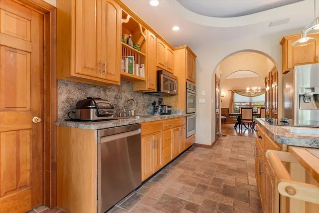 a spacious bedroom with a bed and a chandelier