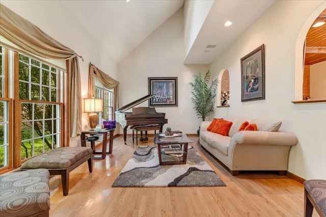 a view of a dining room with furniture a chandelier and wooden floor