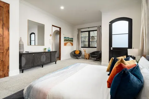 a bedroom with a bed and a large window