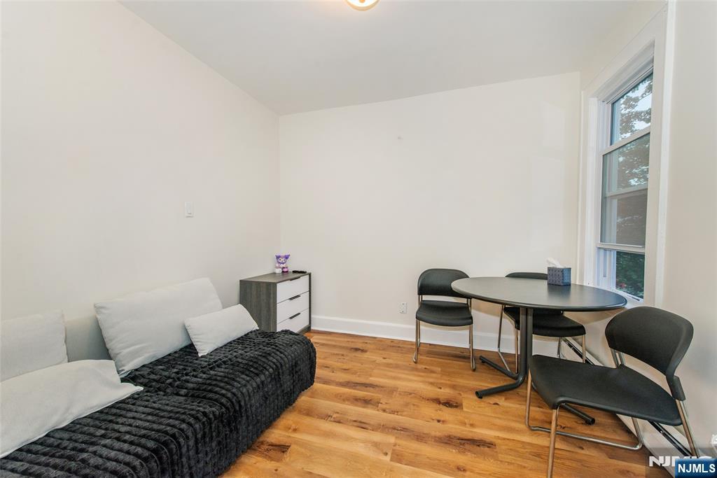 89 King Street Nutley, NJ 07110 - Photo 11 of 32 a bedroom with a bed and a chair