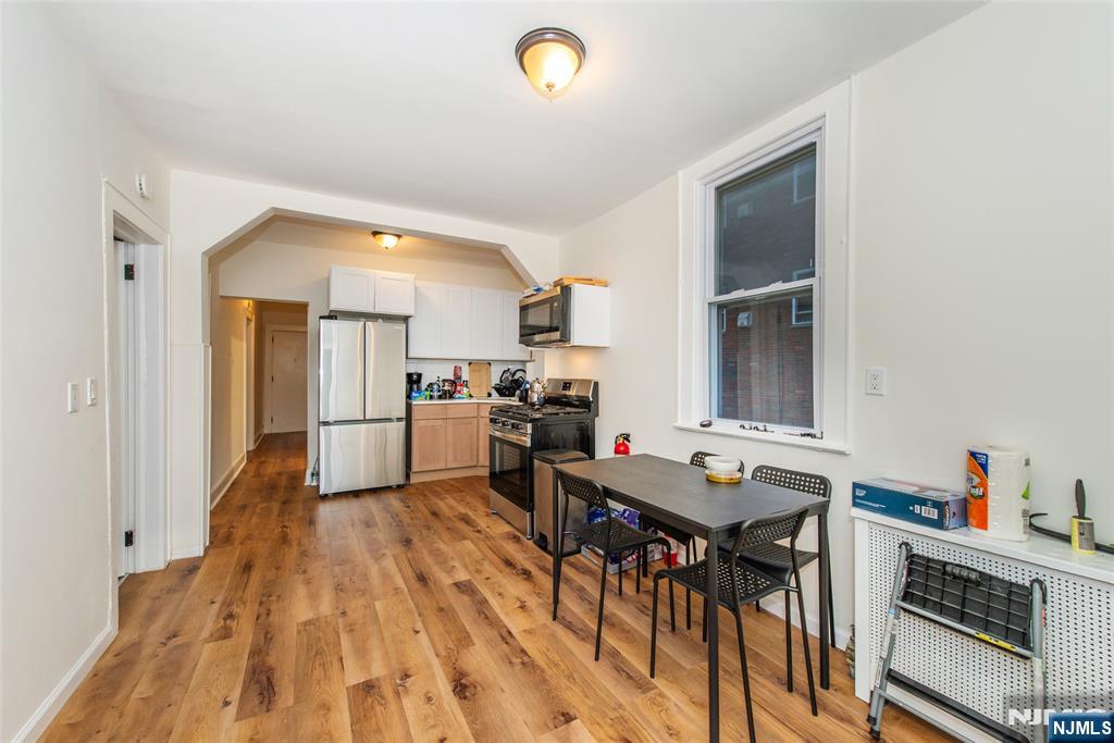 89 King Street Nutley, NJ 07110 - Photo 18 of 32 a kitchen with a table chairs refrigerator and a sink