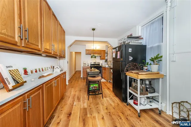 a kitchen with wooden floors and wooden cabinets