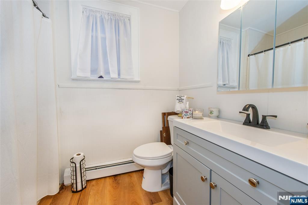 89 King Street Nutley, NJ 07110 - Photo 32 of 32 a bathroom with a sink a toilet and a mirror
