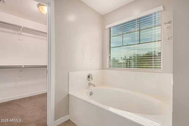 a white bath tub sitting next to a window