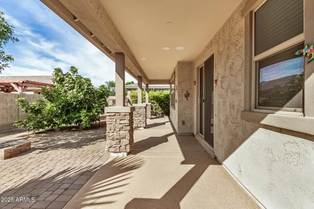a view of a porch with wooden floor and a yard