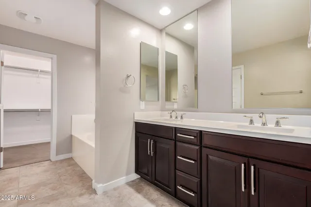 a bathroom with a double vanity sink and mirror