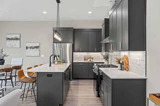 a kitchen with cabinets a sink stainless steel appliances and kitchen view