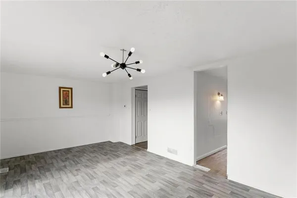 a view of a livingroom with a ceiling fan and wooden floor