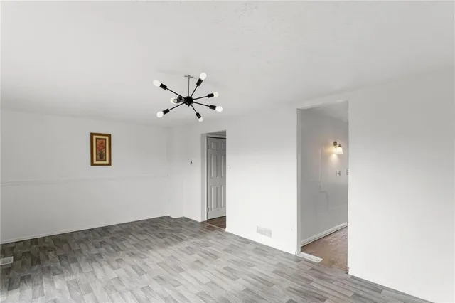 a view of a livingroom with a ceiling fan and wooden floor