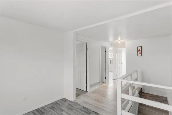 a view of wooden floor and windows in a room