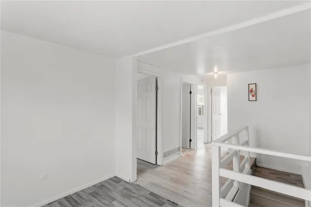 a view of wooden floor and windows in a room