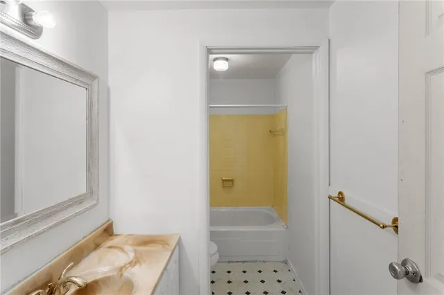 a bathroom with a tub and shower