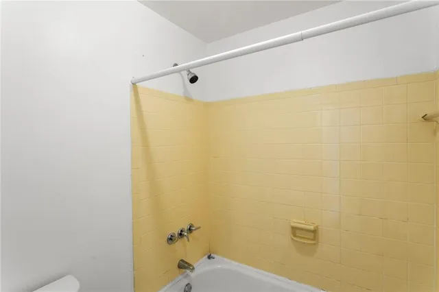 a bathroom with a shower and a toilet