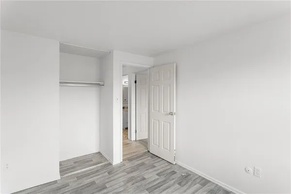 a view of hallway with wooden floor
