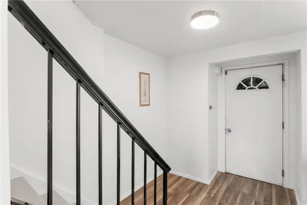 a view of entryway with wooden floor and stairs