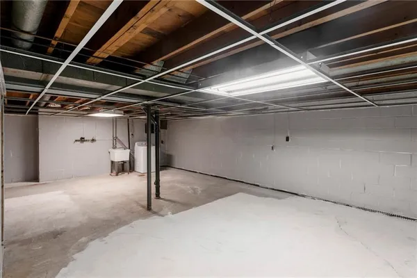 a backyard of a house with barbeque oven table and chairs