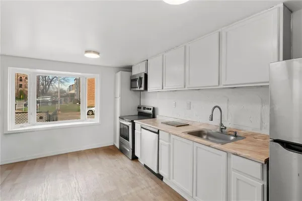 a kitchen with a sink stove and cabinets