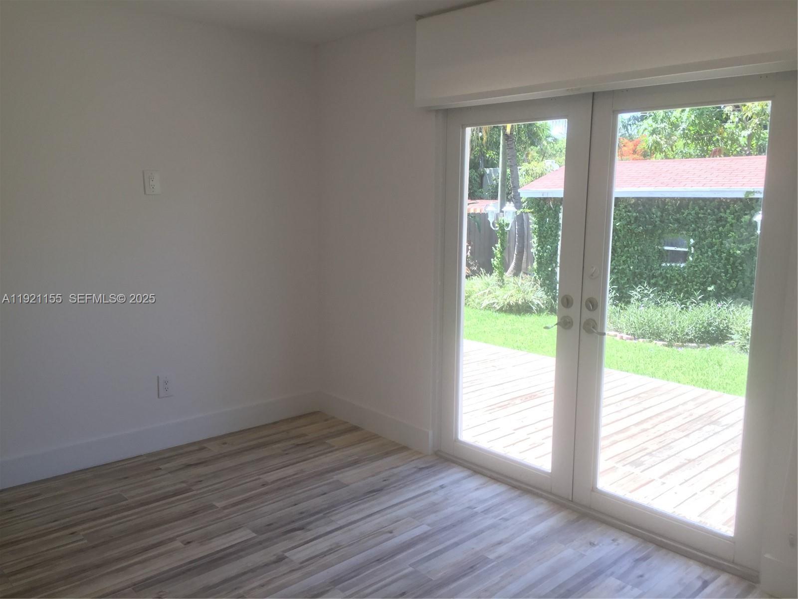 1831 Southwest 17th Terrace Miami, FL 33145 - Photo 16 of 21 a view of an empty room with wooden floor and a window