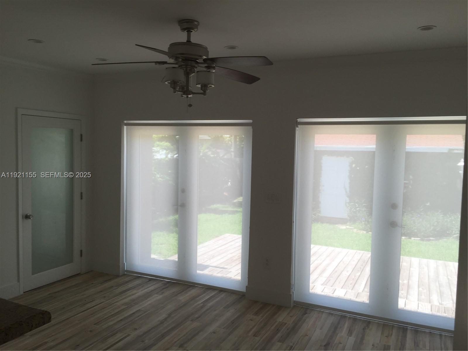 1831 Southwest 17th Terrace Miami, FL 33145 - Photo 4 of 21 a view of an empty room with wooden floor and a window