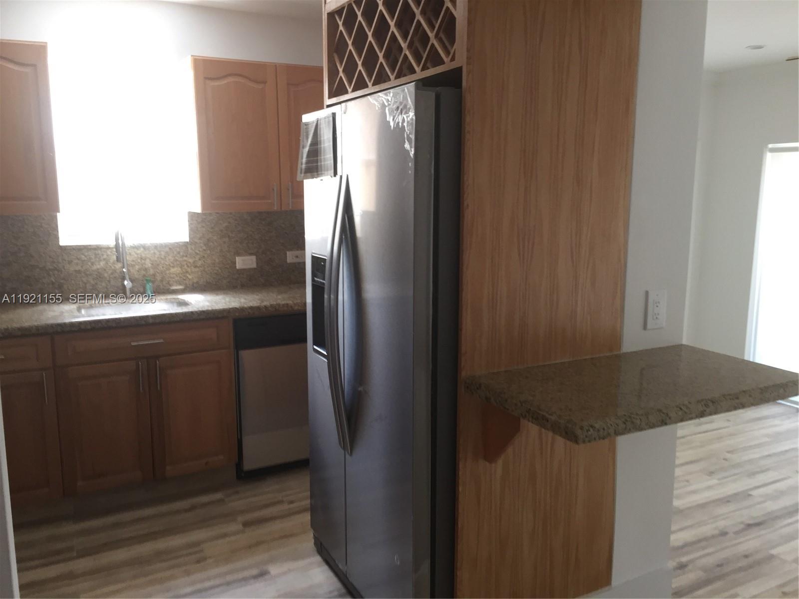 1831 Southwest 17th Terrace Miami, FL 33145 - Photo 6 of 21 a kitchen with metallic refrigerator and sink