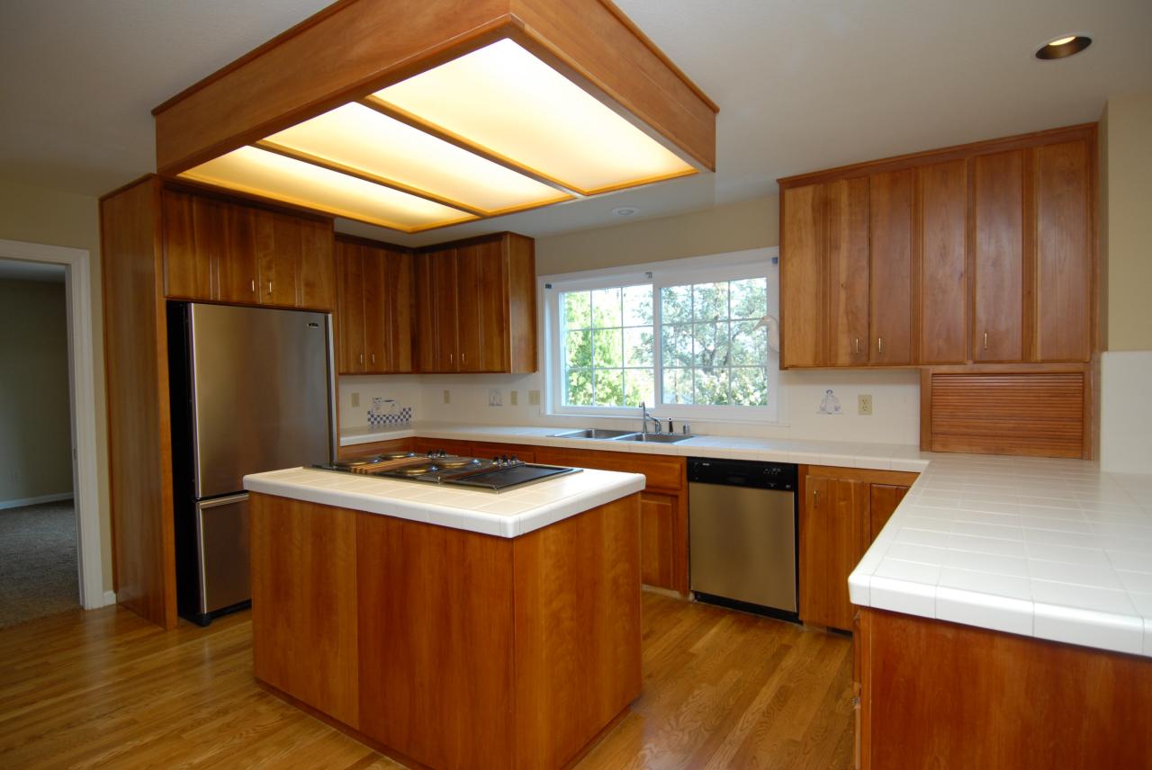 15855 Montgomery Ranch Road Redding, CA 96001 - Photo 11 of 12 a kitchen with stainless steel appliances granite countertop refrigerator sink and cabinets