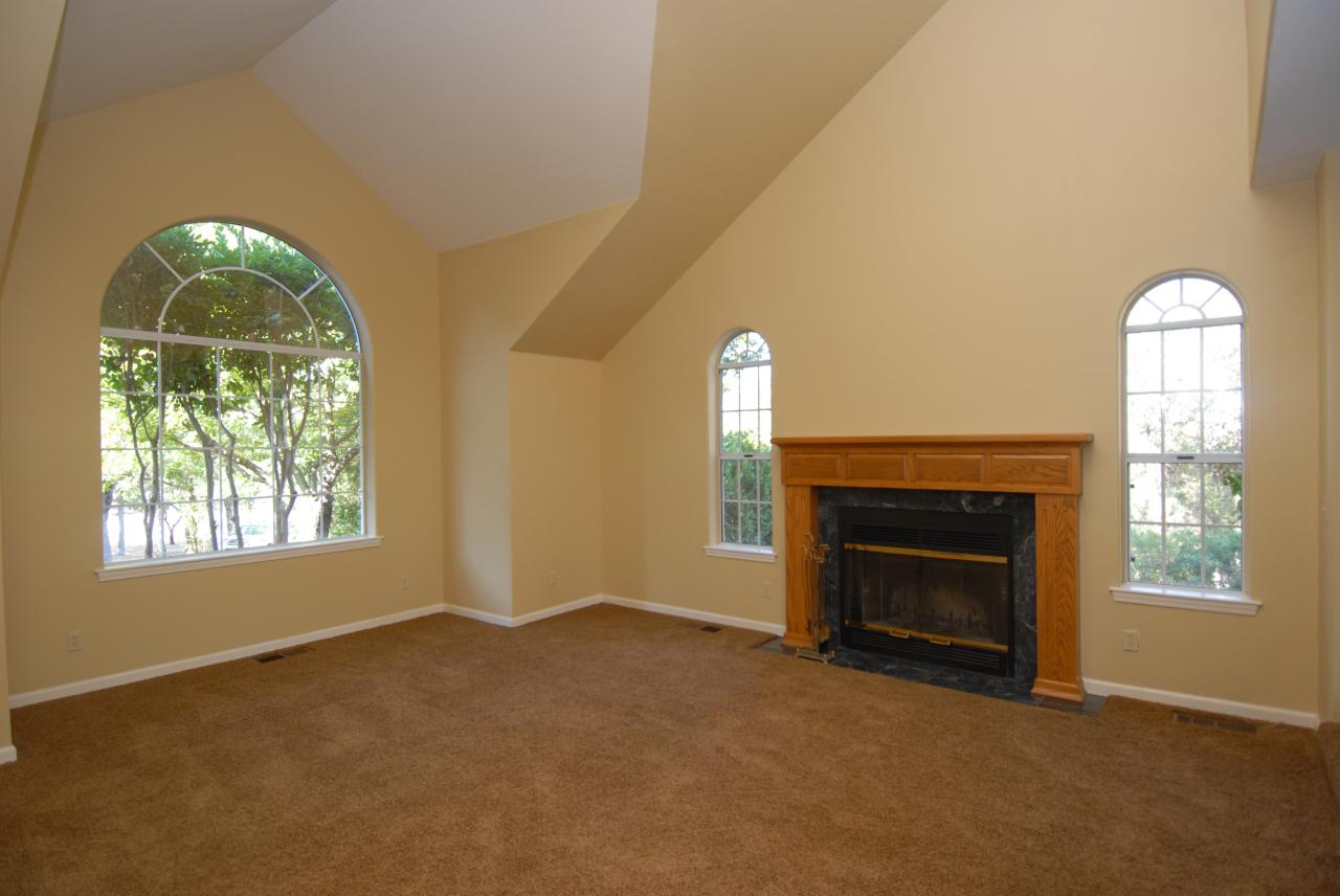 15855 Montgomery Ranch Road Redding, CA 96001 - Photo 8 of 12 an empty room with windows fireplace and mirror