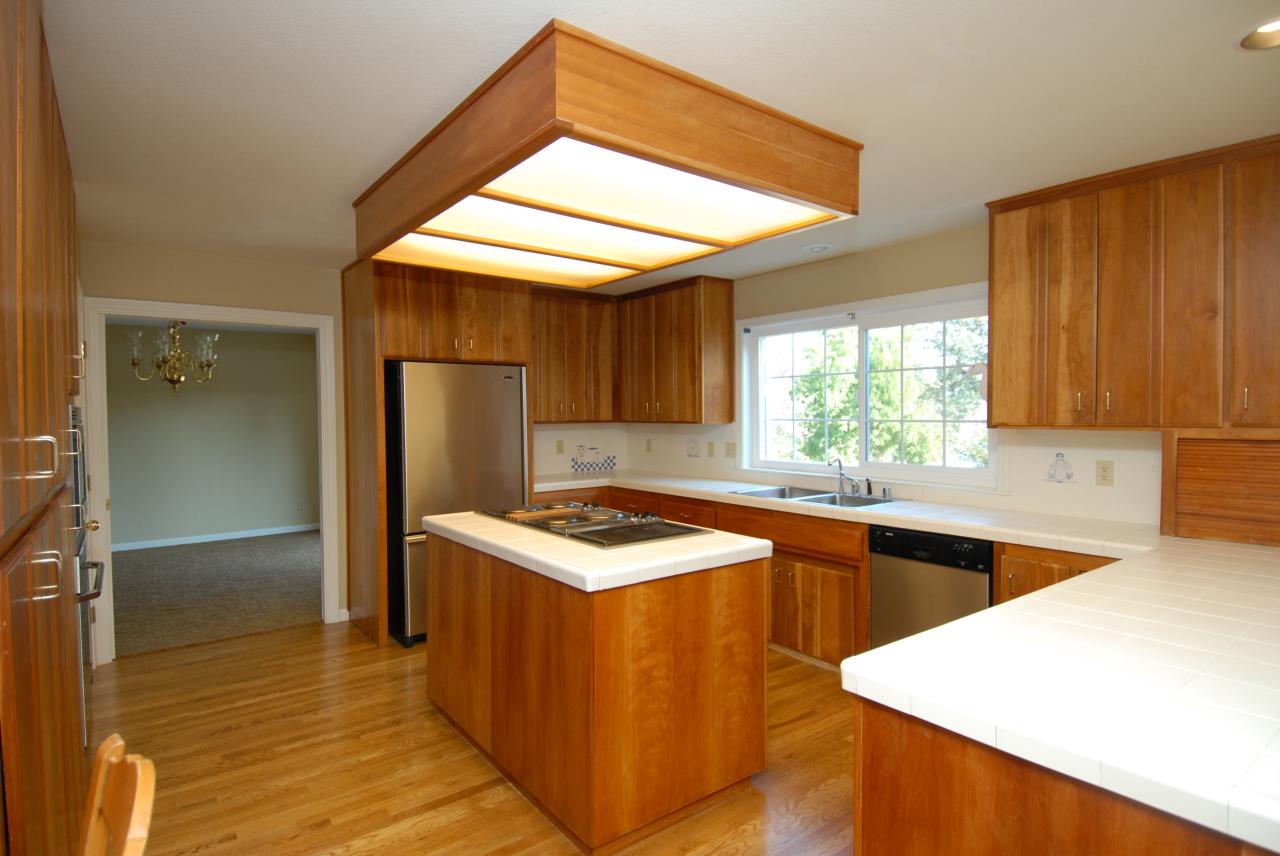 15855 Montgomery Ranch Road Redding, CA 96001 - Photo 10 of 12 a kitchen with stainless steel appliances granite countertop a sink a stove and a refrigerator