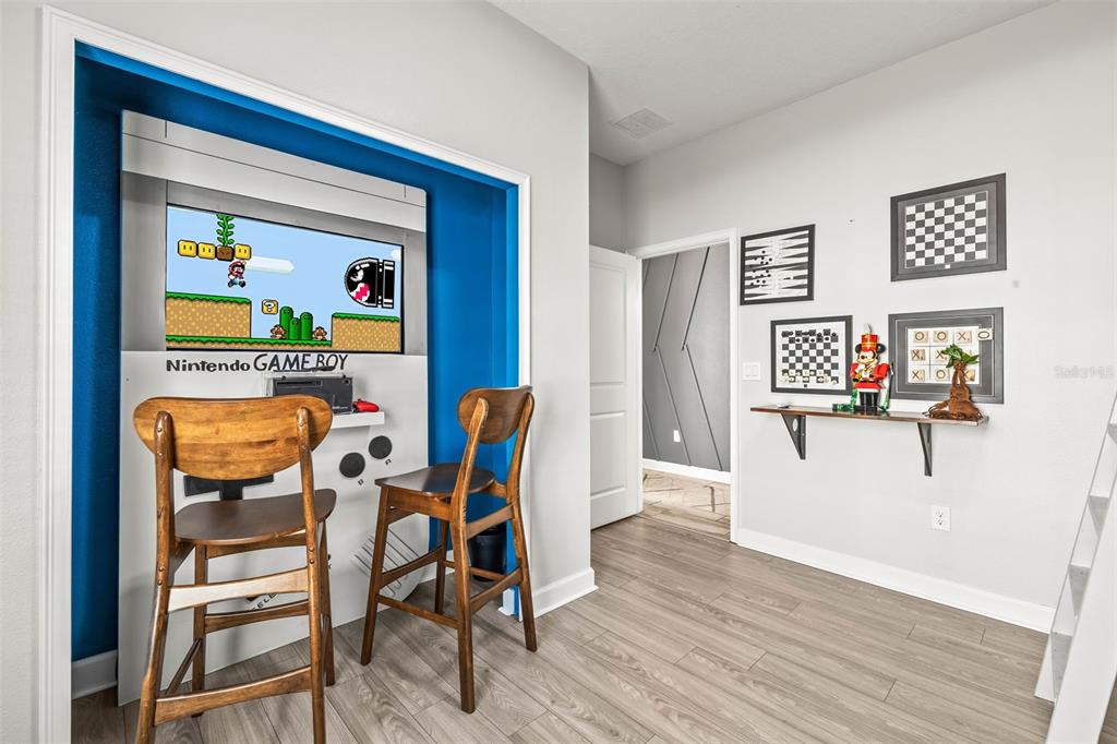 4895 Romeo Circle Kissimmee, FL 34746 - Photo 16 of 93 a view of a workspace with furniture and wooden floor