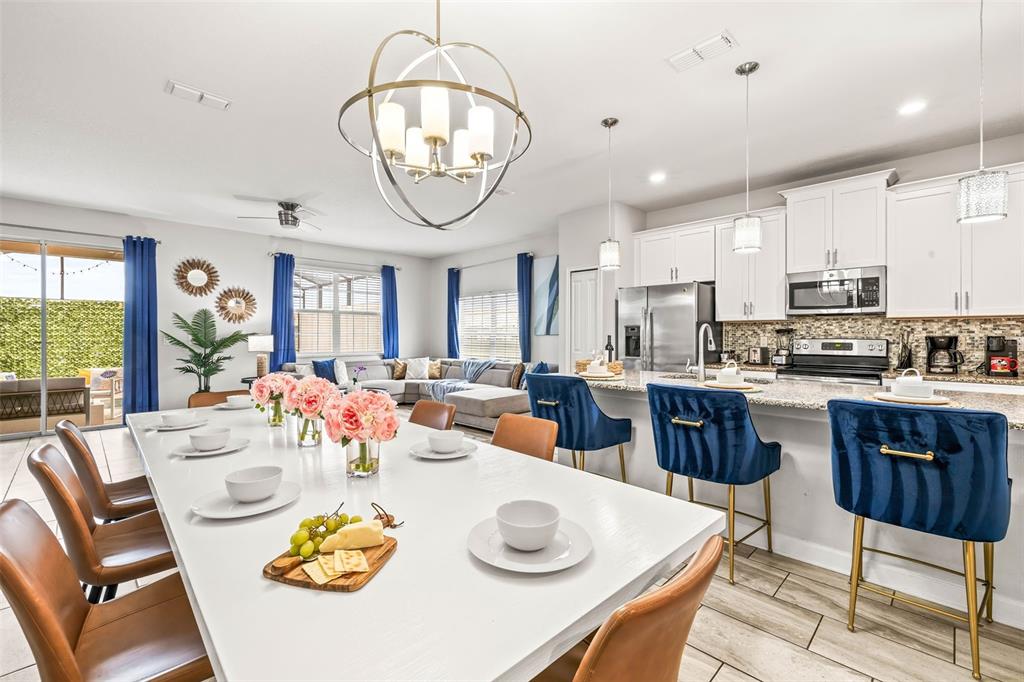 4895 Romeo Circle Kissimmee, FL 34746 - Photo 2 of 93 a view of kitchen with dining table and chairs