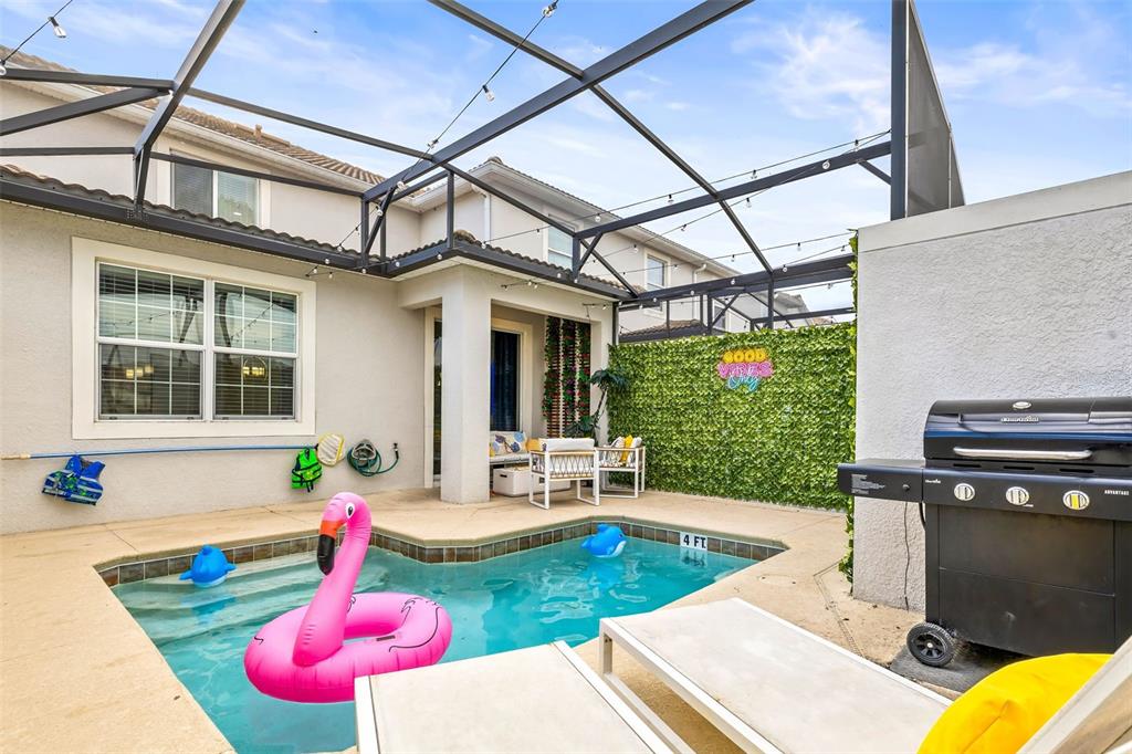 4895 Romeo Circle Kissimmee, FL 34746 - Photo 43 of 93 a view of a patio with table and chairs potted plants