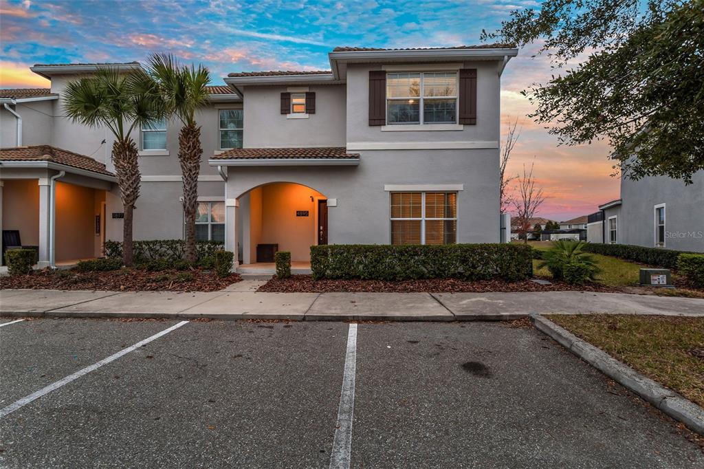 4895 Romeo Circle Kissimmee, FL 34746 - Photo 56 of 93 a front view of a house with a garden