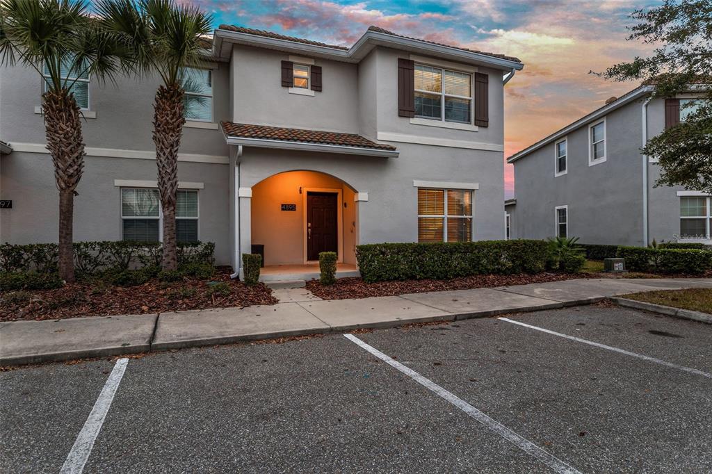 4895 Romeo Circle Kissimmee, FL 34746 - Photo 57 of 93 a front view of a house with yard and parking