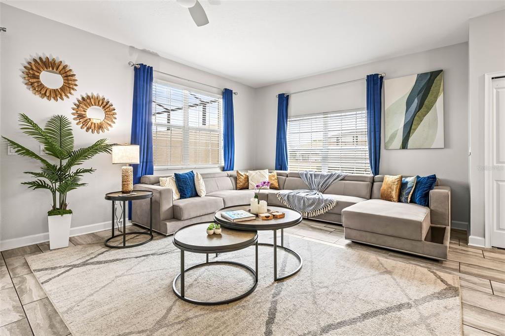 4895 Romeo Circle Kissimmee, FL 34746 - Photo 7 of 93 a living room with furniture potted plant and a large window