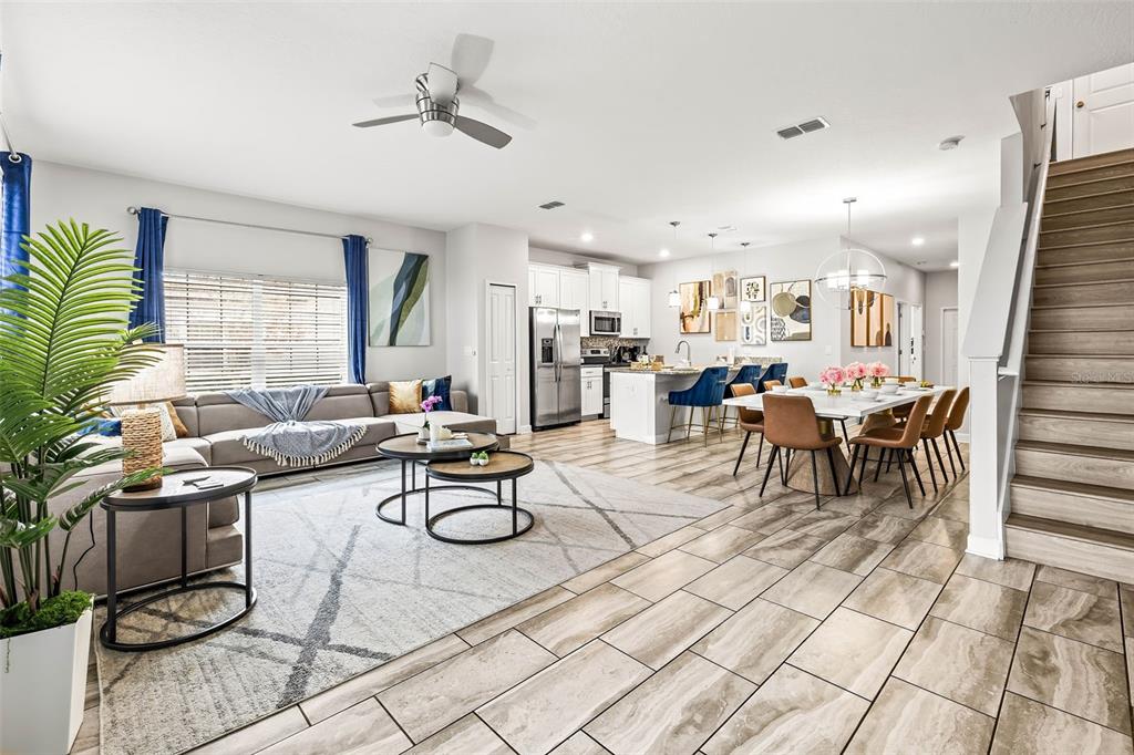 4895 Romeo Circle Kissimmee, FL 34746 - Photo 8 of 93 a view of kitchen with stainless steel appliances kitchen island granite countertop dining table chairs sink and cabinets