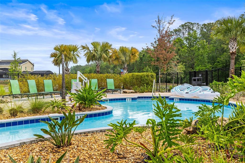 4895 Romeo Circle Kissimmee, FL 34746 - Photo 81 of 93 a view of a swimming pool with a patio and a yard