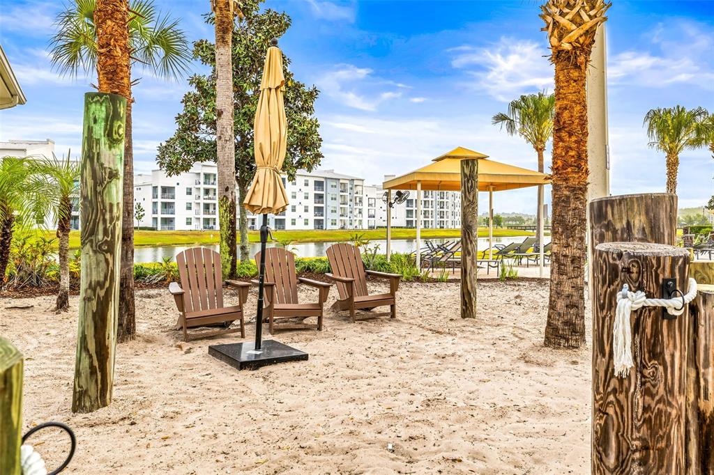 4895 Romeo Circle Kissimmee, FL 34746 - Photo 90 of 93 a view of a swimming pool with a lounge chairs