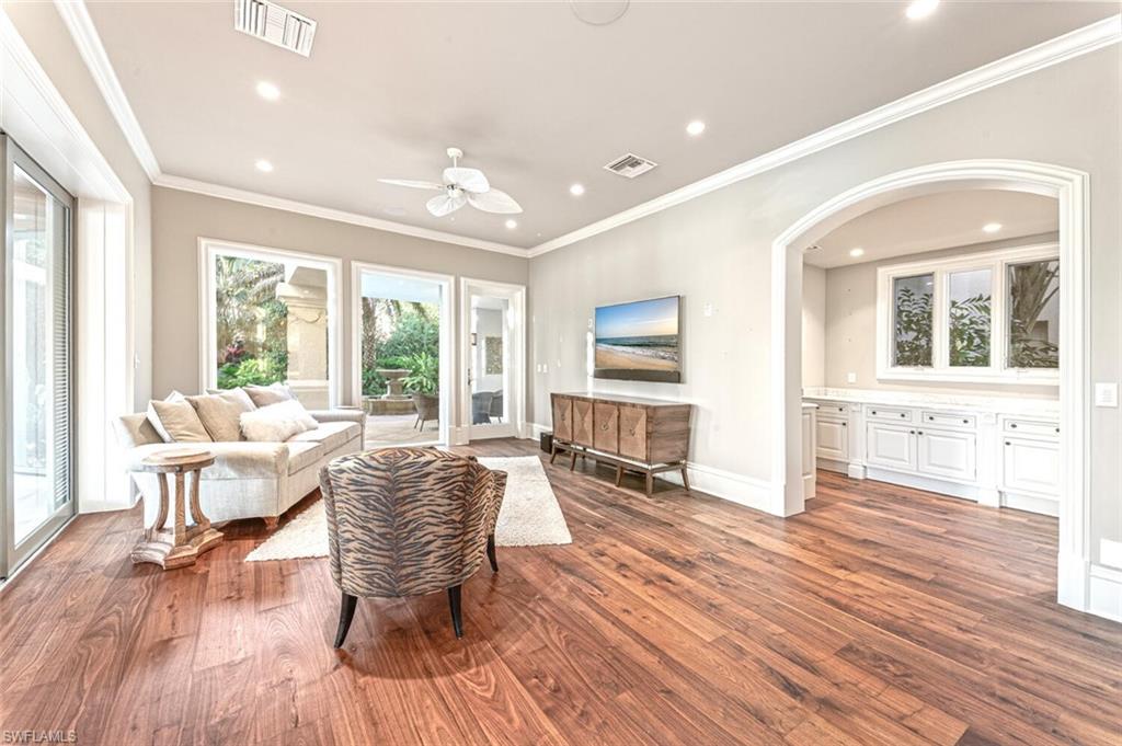 7331 Tilden Lane Naples, FL 34108 - Photo 16 of 50 a living room with furniture and a large window