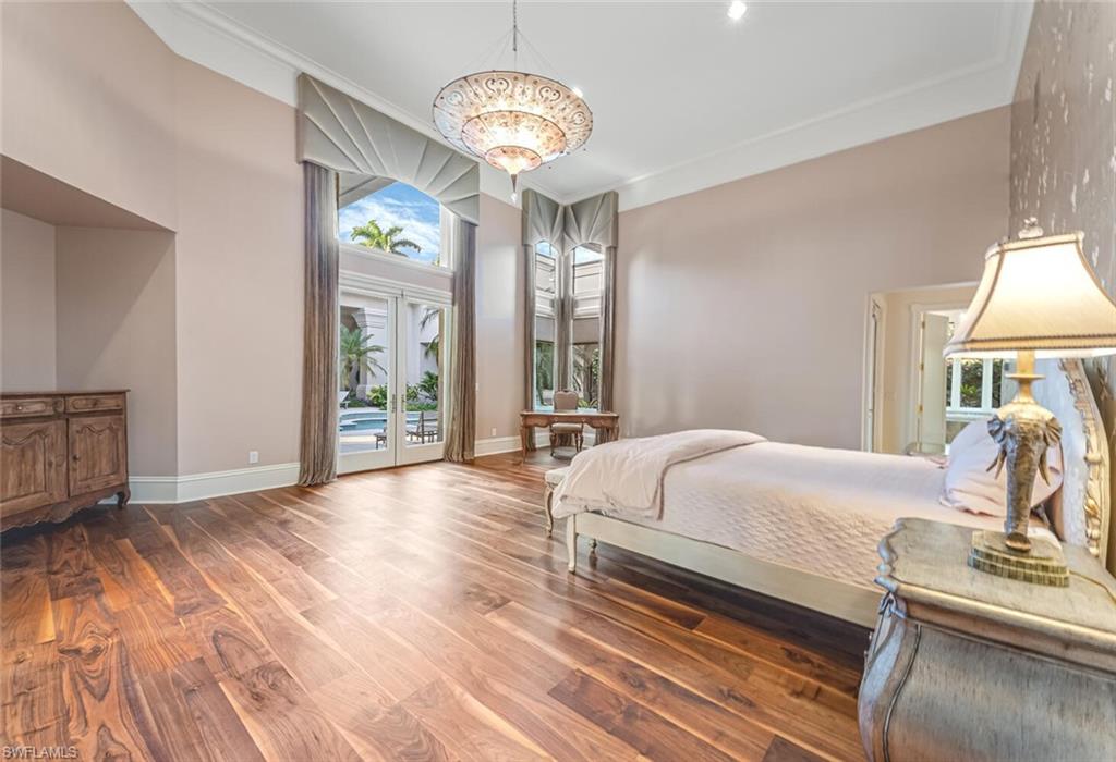 7331 Tilden Lane Naples, FL 34108 - Photo 18 of 50 a bedroom with a bed and wooden floor