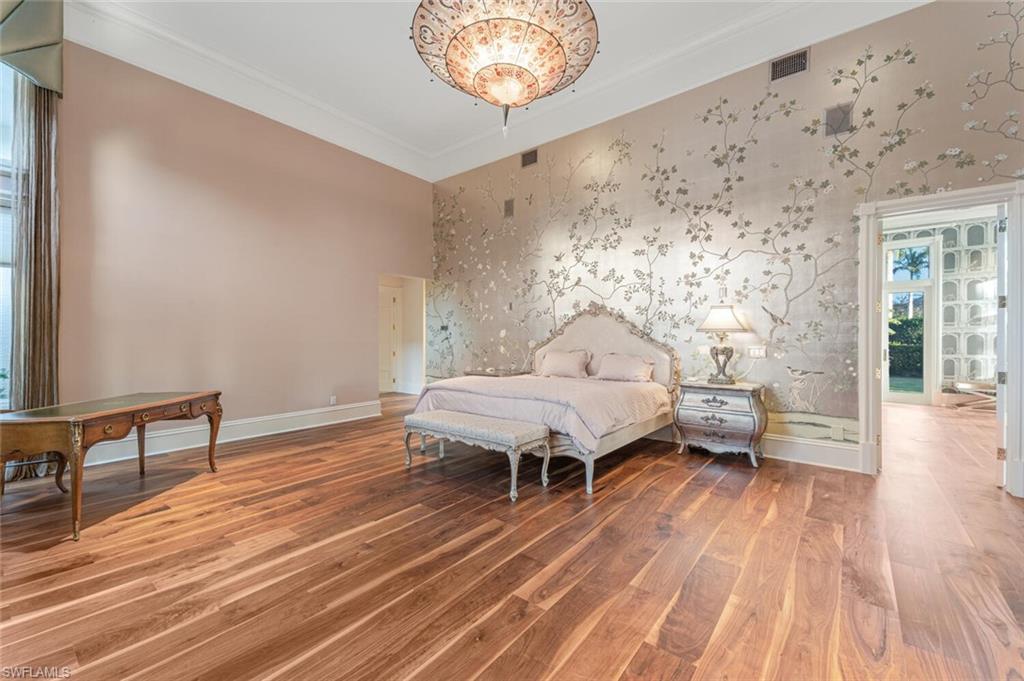 7331 Tilden Lane Naples, FL 34108 - Photo 19 of 50 a spacious bedroom with a bed and a table