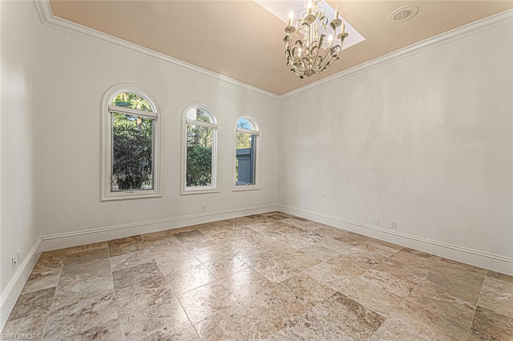7331 Tilden Lane Naples, FL 34108 - Photo 26 of 50 a view of an empty room with window and chandelier fan