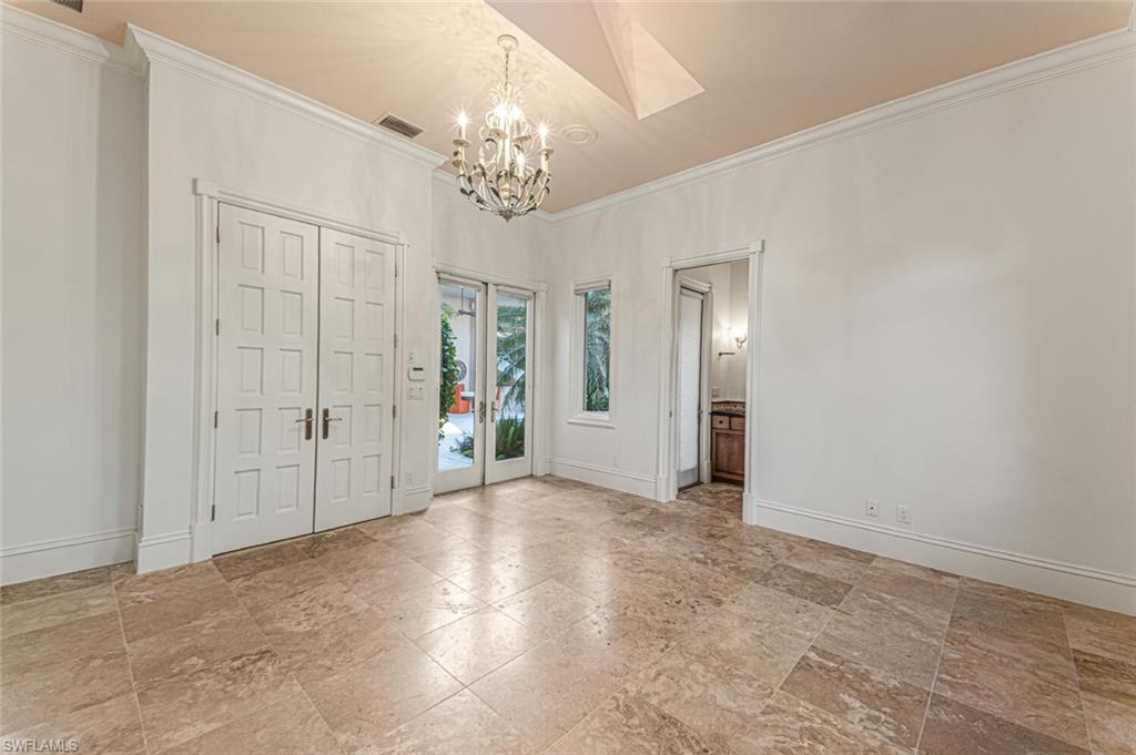 7331 Tilden Lane Naples, FL 34108 - Photo 27 of 50 a view of an empty room with chandelier