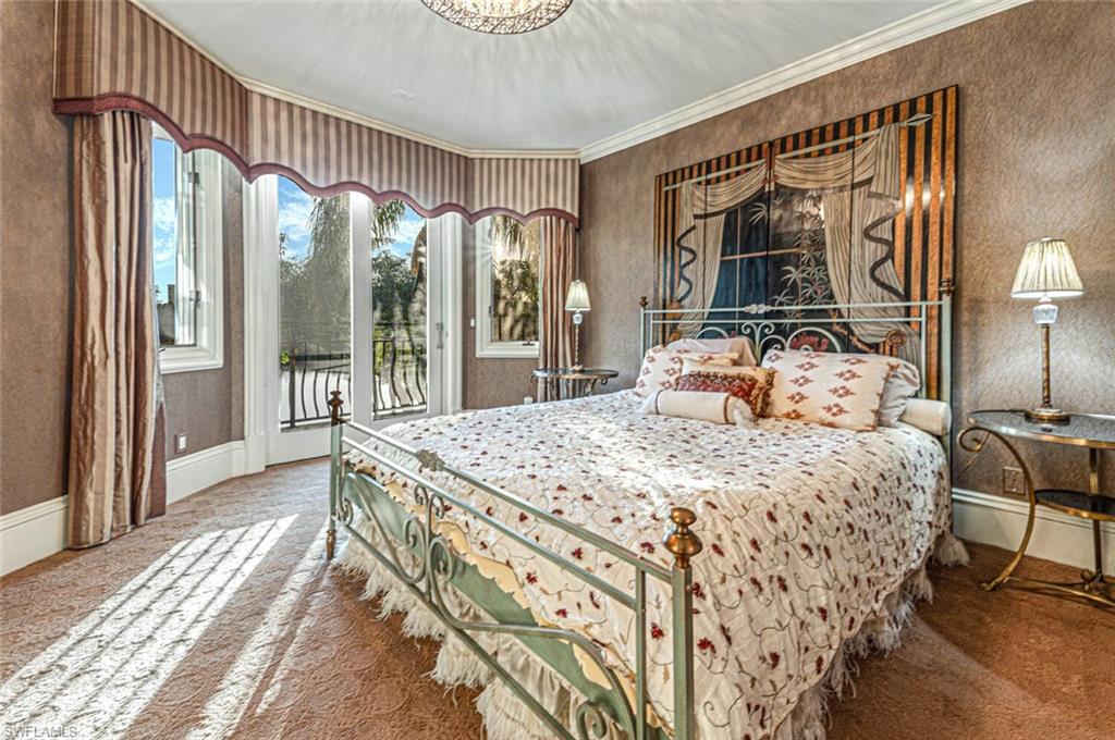 7331 Tilden Lane Naples, FL 34108 - Photo 33 of 50 a bedroom with a bed mirror and a large window