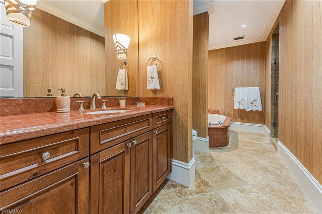 7331 Tilden Lane Naples, FL 34108 - Photo 36 of 50 a spacious bathroom with a granite countertop sink mirror and toilet