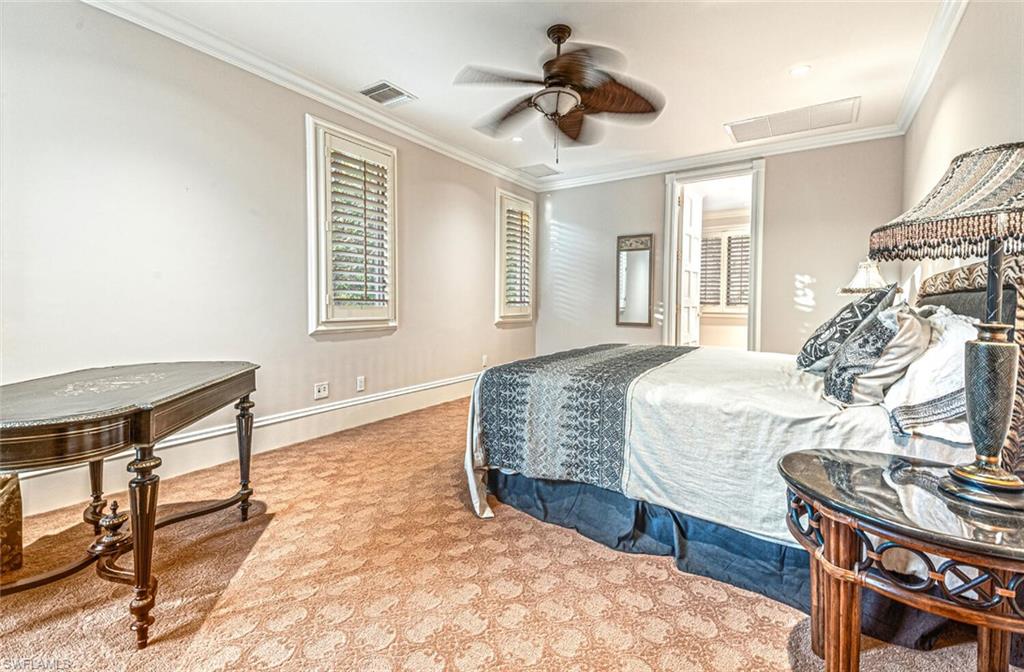 7331 Tilden Lane Naples, FL 34108 - Photo 38 of 50 a bedroom with a bed and a table in it