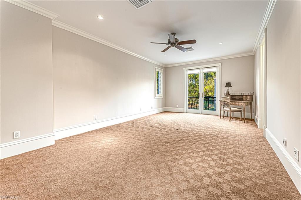 7331 Tilden Lane Naples, FL 34108 - Photo 40 of 50 en empty room with windows and ceiling fan