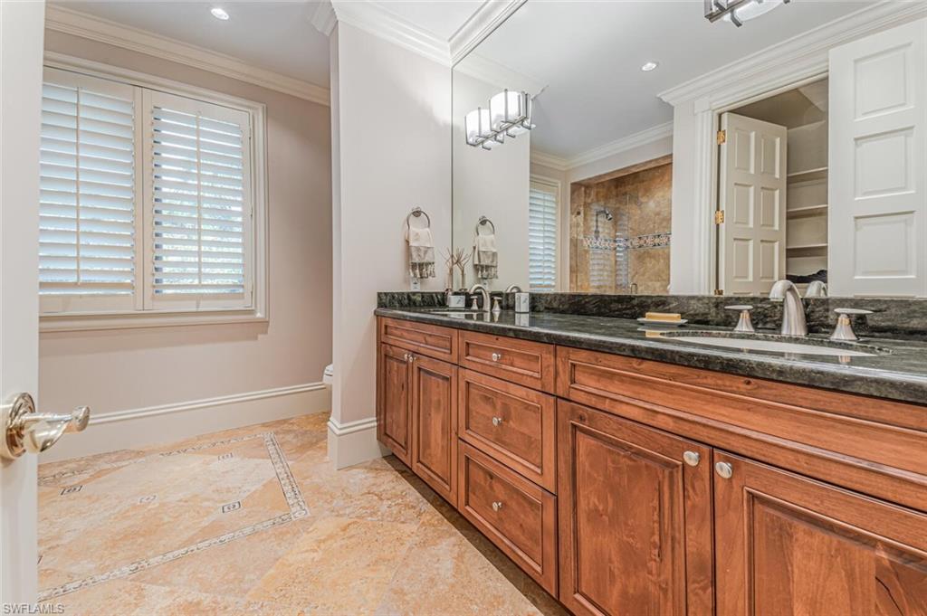 7331 Tilden Lane Naples, FL 34108 - Photo 41 of 50 a bathroom with a granite countertop sink and a mirror
