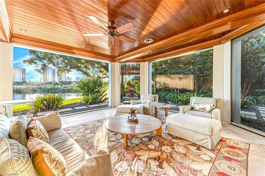 7331 Tilden Lane Naples, FL 34108 - Photo 43 of 50 a living room with patio furniture and a large window