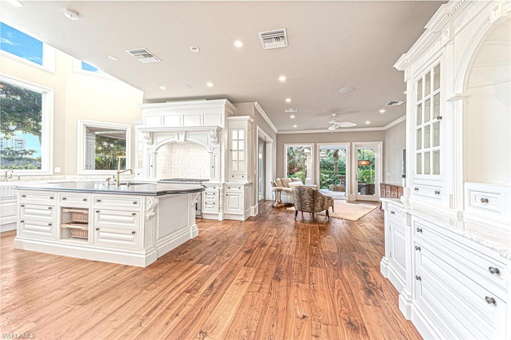 7331 Tilden Lane Naples, FL 34108 - Photo 9 of 50 a large room with stainless steel appliances kitchen island granite countertop a large window and white cabinets