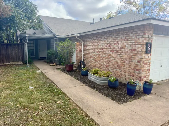 a view of a patio with plants and chairs