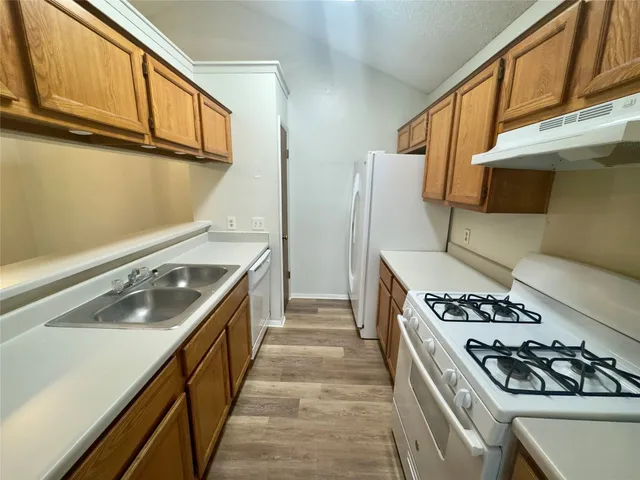 a kitchen that has a sink and a stove